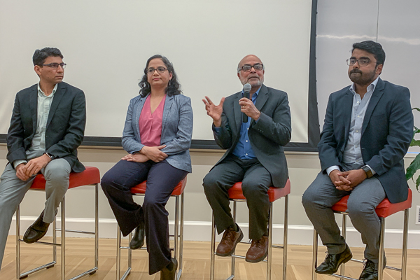 Authors speaking on a panel at the launch event