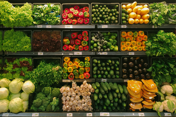 rows of vegetables in a grocery store cooler