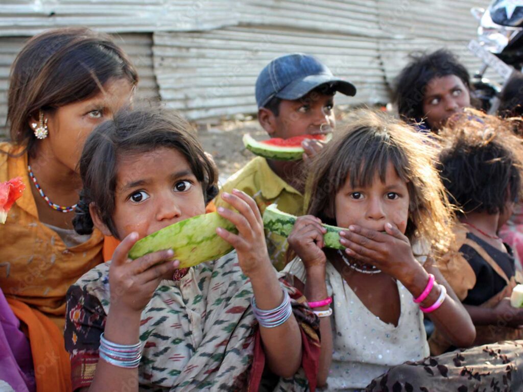 Children eating watermelon.
