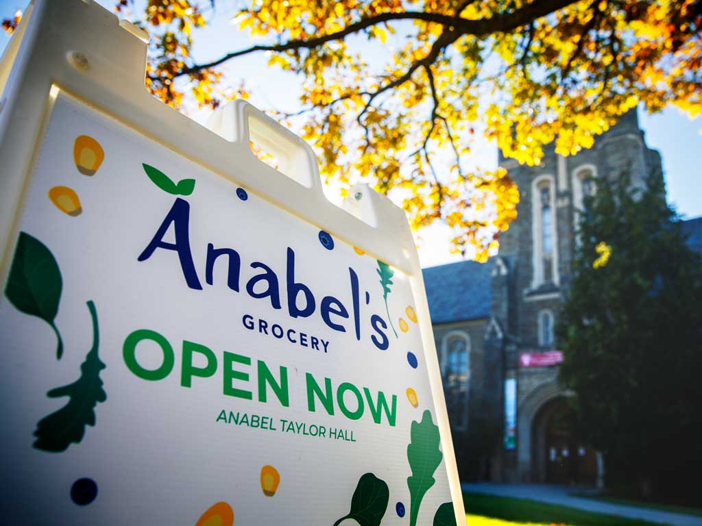 Anabel’s Grocery open sign in front of a Cornell University building.