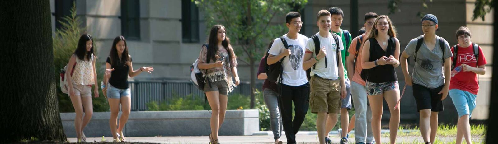Students walk along the sidewalk in the Ag Quad on campus.