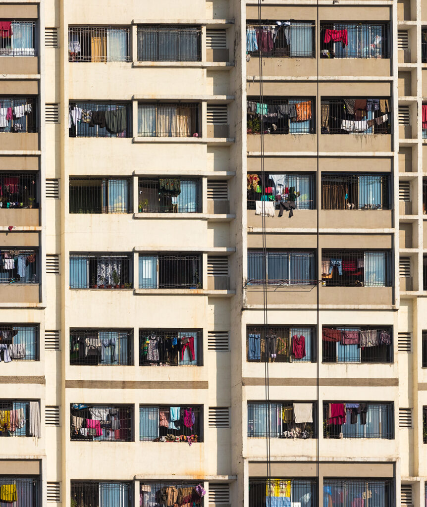 Facade of an apartment building with clothes handing on the balconies.