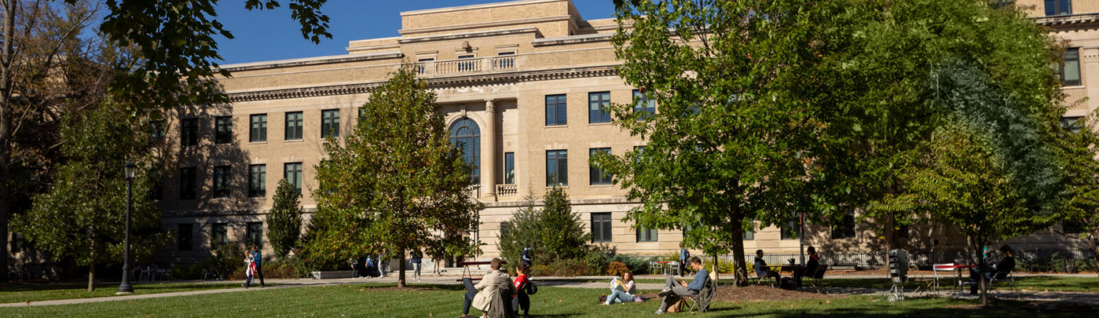 Exterior of Warren Hall with students milling about the Ag Quad.