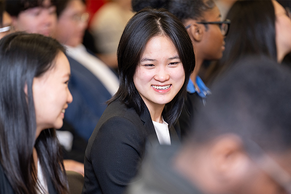 A person smiling in business attire.