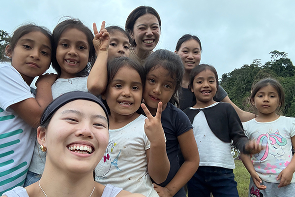 College students with a group of children during a trip to San Martin, Peru.