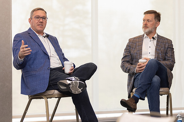 Daniel Cane '98, left, joined Tim Barry ’93, right, for a chat during the Celebration Ezra event